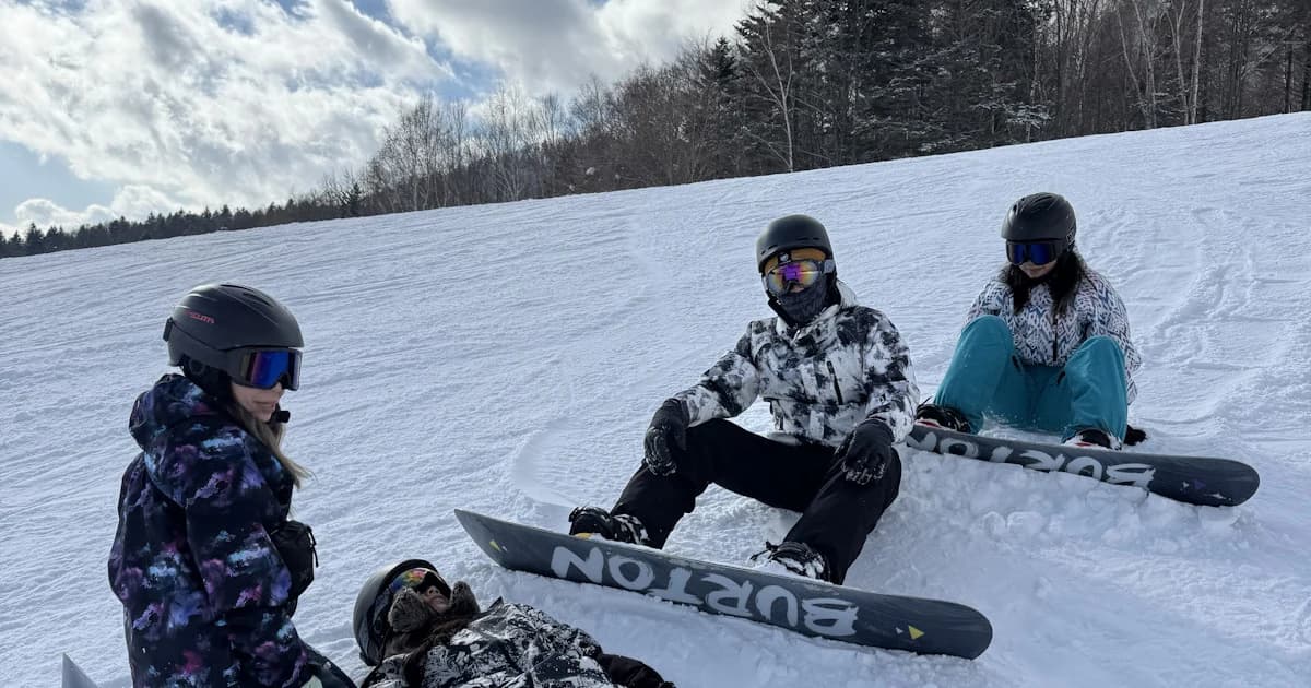 孩子在北海道雪場緩坡上練習滑雪板的冬季照片